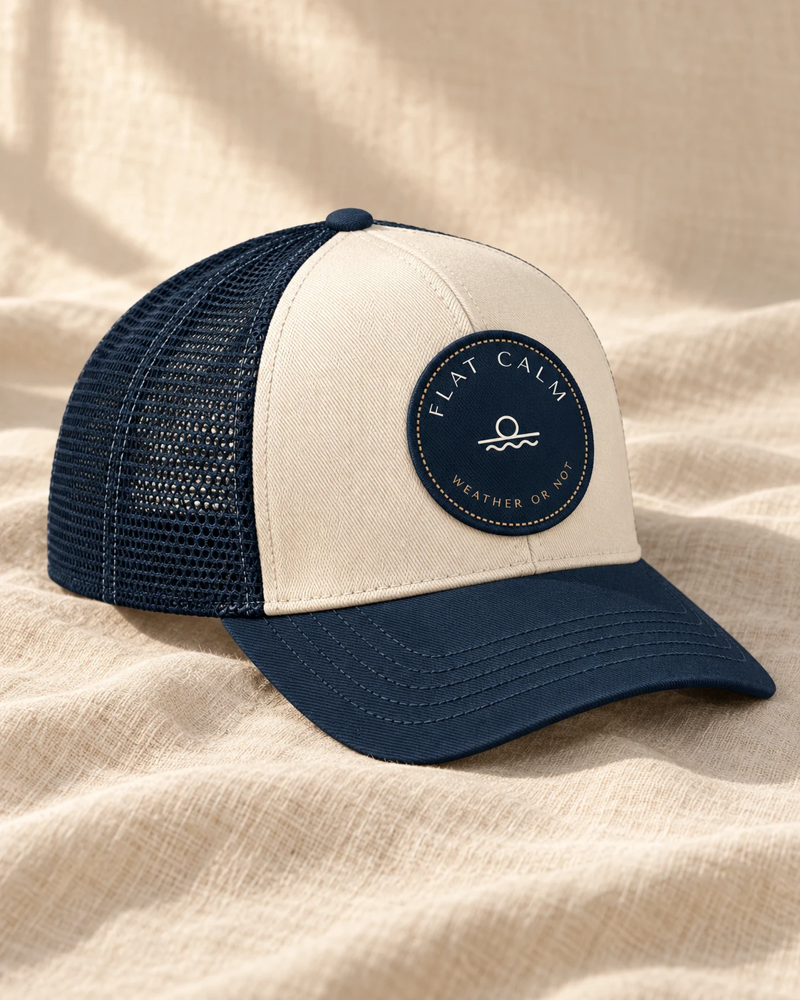 Cream and navy trucker cap with the round Weather or Not patch